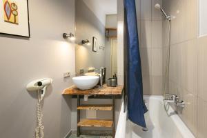 a bathroom with a sink and a bath tub and a sink at Baltic Design Apartments with free Parking and self check in in Rīga +51 photos