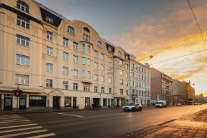 a city street with a building and cars on the road at Baltic Design Apartments with free Parking and self check in in Rīga