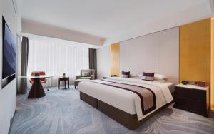 Postel nebo postele na pokoji v ubytování Kunshan Yu Yuan Garden Hotel + 22 fotografií