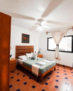 a bedroom with a bed and a ceiling fan at Hotel Boutique Canto Del Agua in Chiconcuac