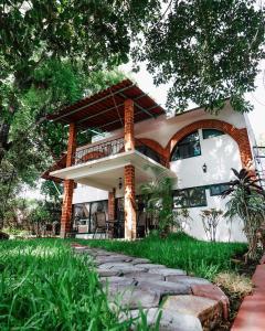 a large house with a balcony on the side of it at Hotel Boutique Canto Del Agua in Chiconcuac
