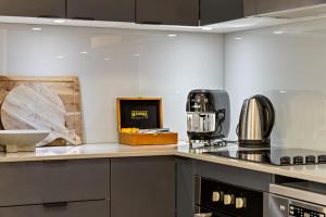 a kitchen with a stove and a counter top at Byron Getaway @the Crest in Byron Bay