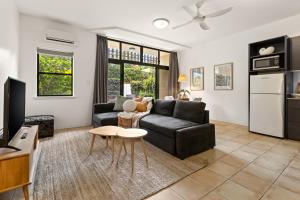 a living room with a couch and a table at Byron Getaway @the Crest in Byron Bay