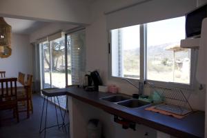 a kitchen with a sink and a window at Sierras de Paz in Villa Giardino