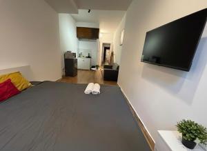 a bedroom with a bed and a flat screen tv at Ha Noi Old Quarter Apartment L'Thao in Hanoi