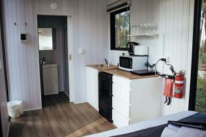 uma cozinha com uma pia e um micro-ondas em um balcão em Solitary Islands Farm 2 by Tiny Away em Arrawarra