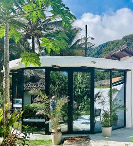 a pavilion with palm trees and a person in it at Hotel Villa La Fortuna in Filipina