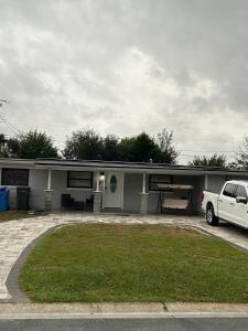 a white truck parked in front of a house at Luxury&Home in Tampa