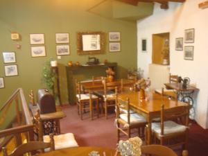 a dining room with wooden tables and chairs at Pension Maria in Arachova
