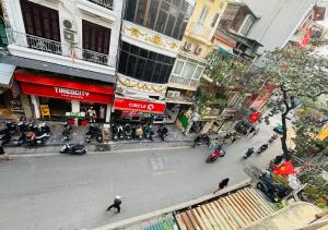 an overhead view of a busy city street with people on motorcycles at Ha Noi Old Quarter Apartment L'Thao in Hanoi +8 photos