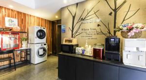 a laundry room with a washer and dryer on a counter at Jukdo market G1mini in Pohang