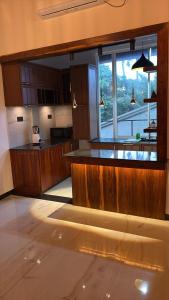 a kitchen with wooden cabinets and a large window at Kaveen Homes in Mount Lavinia +5 photos