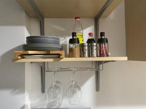 a shelf with wine bottles and glasses in a kitchen at City Clou in Cebu City