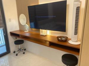 a flat screen tv sitting on top of a wooden shelf at City Clou in Cebu City +12 photos