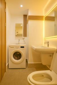 a bathroom with a washing machine and a sink at City Clou in Cebu City