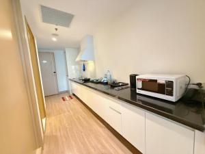 a kitchen with a counter top with a microwave at Grands StarCity in Nha Trang
