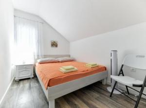 a white bedroom with a bed and a white chair at Villa Kate in Pašman +27 photos