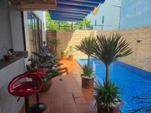 a patio with potted plants and a swimming pool at Villa 88 in Tân Thành (1)