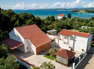 an aerial view of a house with the ocean in the background at Villa Kate in Pašman