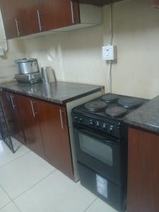 a kitchen with a black stove and a counter at Clark lodge at 272 in Durban