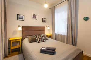 a bedroom with a bed with two towels on it at Baltic Design Apartments with free Parking and self check in in Rīga