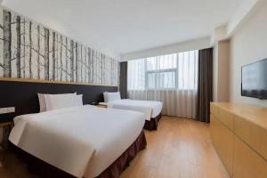 En eller flere senge i et værelse på Starway Hotel Suzhou Shishan Road High-Tech Plaza