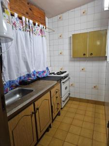 een keuken met een spoelbak en een fornuis bij Espacio ideal in Mar de Ajó