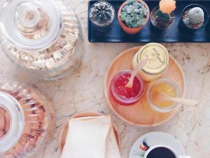 a table topped with plates and bowls of food at At home boutique in Ban Long