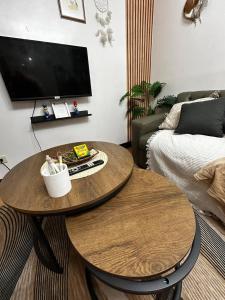 een woonkamer met 2 tafels en een bank bij Chic Haven Home away from home in Imus