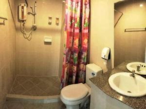 a bathroom with a toilet and a sink and a shower at Loei Orchid Hotel in Ban Tha Phae +61 photos