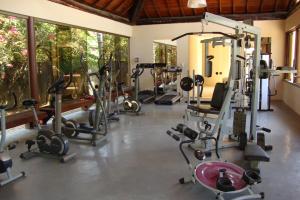 a gym with a bunch of exercise equipment in a room at Nannai Beira Mar Porto de Galinhas 307 in Porto De Galinhas