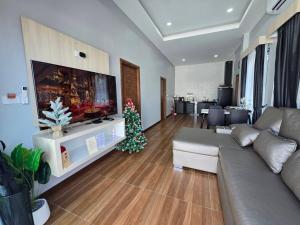 a living room with a couch and a christmas tree at TiTIME POOL VILLA in Ao Nang 