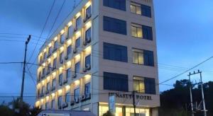 a building with lights on the side of it at Hotel Dynasty in Sibengkok