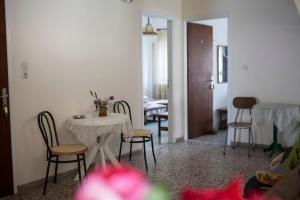 a room with a table and chairs and a dining room at Hotel Kima in Kamariotissa