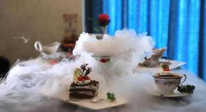 a table topped with a piece of cake and a cup of tea at James Joyce Coffetel Golmud Huaxing Plaza Branch in Golmud