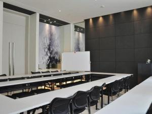 a conference room with a white board and chairs at Jinjiang Inn Select Xuzhou Suning Plaza Jinguang East Road in Xuzhou
