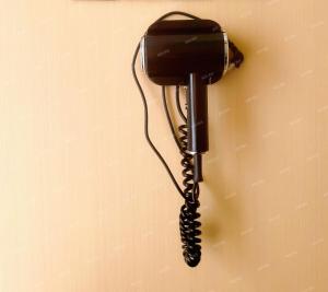 a black phone is hanging on a wall at 上海屿眠酒店 in Shanghai