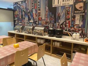 a restaurant with a table and a counter with food at IU Hotel·Tianjin Binhai New District Yanghuo Market in Binhai