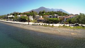 a town next to a body of water with houses at Hotel Kima in Kamariotissa
