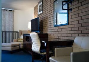 a hotel room with a desk and a television at The Landmark Hotel in Laredo