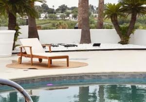 a chair sitting next to a swimming pool at The Landmark Hotel in Laredo