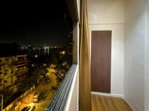 a balcony with a view of a city at night at Palm Breeze Hotel - Colaba in Mumbai