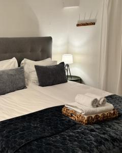 a bed with a pile of towels on it at Sundsvall By M - Basement Studio in Sundsvall