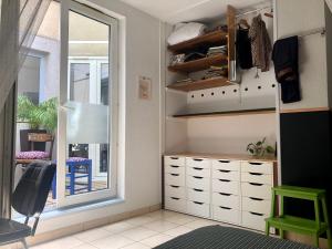 a room with a closet with a mirror and a window at Chez Corinne in Valence