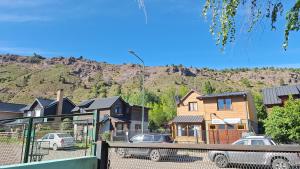 a group of houses with a mountain in the background at Habitacion Privada en Casa de Ale in San Martín de los Andes