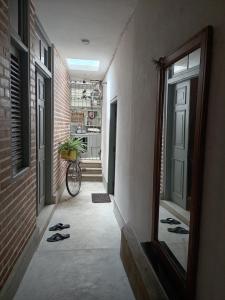 a hallway with a bike parked in a building at Vintekta Cottage in Weligama