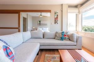 a living room with a couch and a window at Horizon on The Beach at The Sands in Onetangi
