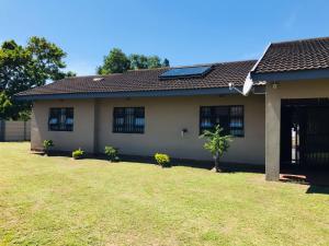 a house with a solar panel on top of it at Mhlezi Lodge in Richards Bay