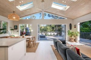 an open kitchen and living room with skylights at Skyview Onetangi - Stay Waiheke in Waiheke Island