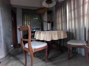 a dining room table with two chairs and a table and a table and chairsktop at Vintekta Cottage in Weligama